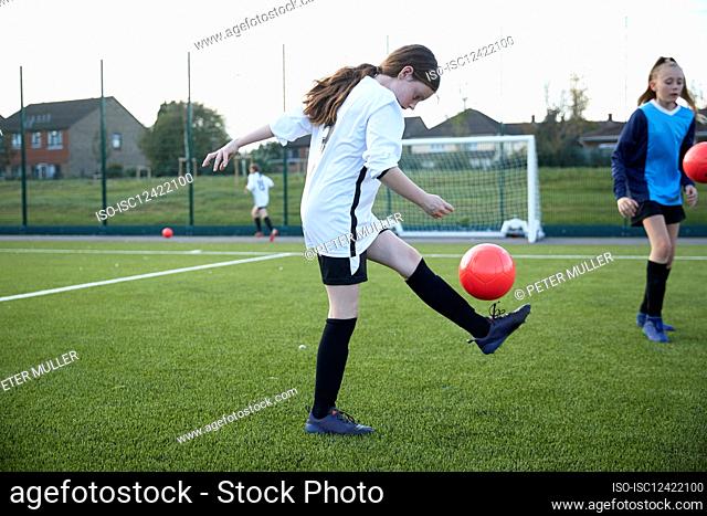 UK, Girls soccer team having training in field