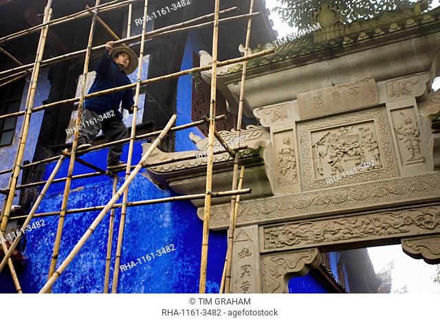 Workman carries out restoration repairs at City of Ghosts, Fengdu, China