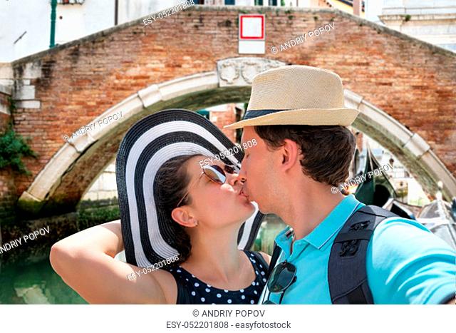 Close-up Of Tourist Couple Kissing On Venice Street Taking Selfie