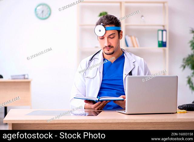 Young male doctor working in the clinic hospital