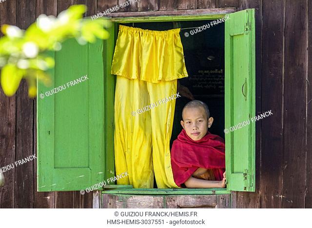 Myanmar (Burma), Shan state, Hsipaw, young monk looking out the window of a monastery