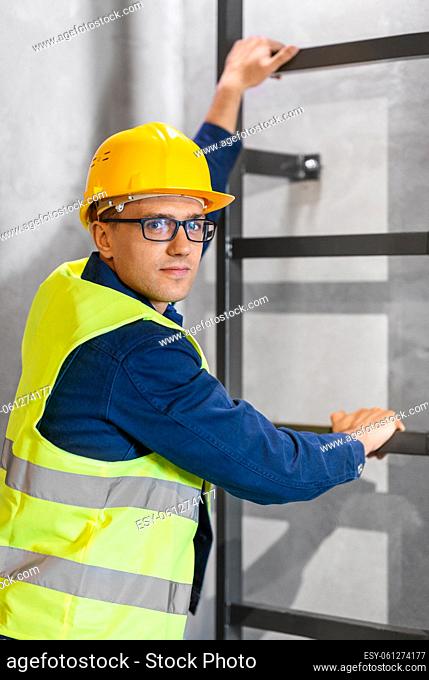architect in helmet and goggles climbing stairs