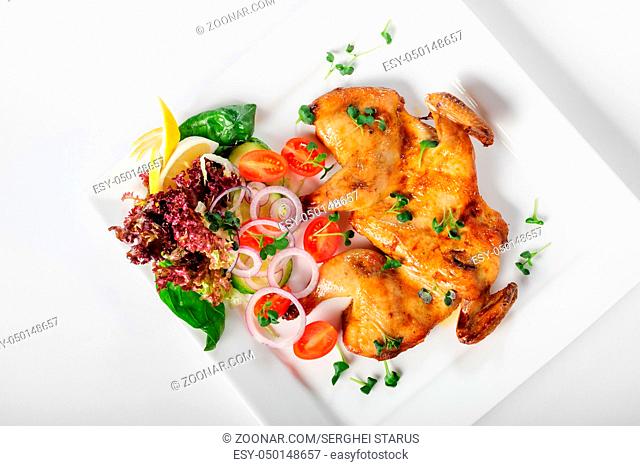 Chicken Tabaka with svegetable salad. Georgian or Caucasian cuisine. Top view