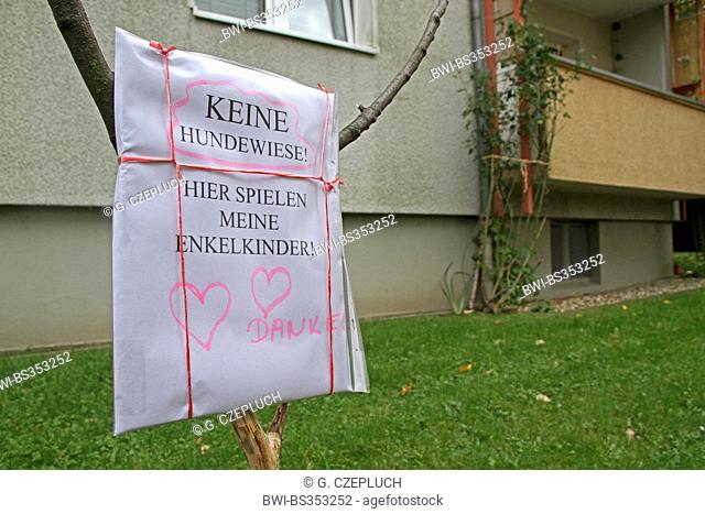 handmade sign on lawn against dog dirt, Germany
