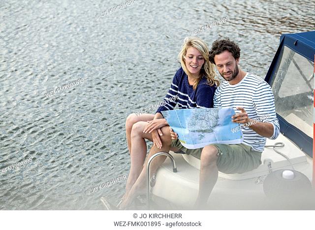 Couple on boat looking at map