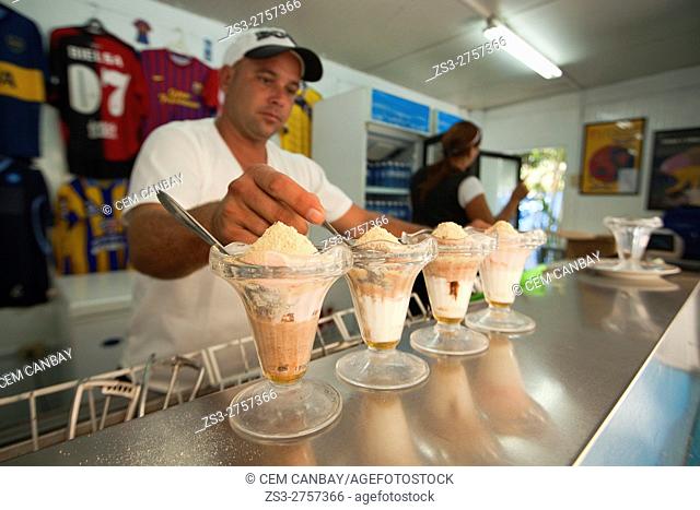 Vendor preparing ice creams in the ice cream shop Coppelia in Vedado district, Havana, La Habana, Cuba, West Indies, Central America