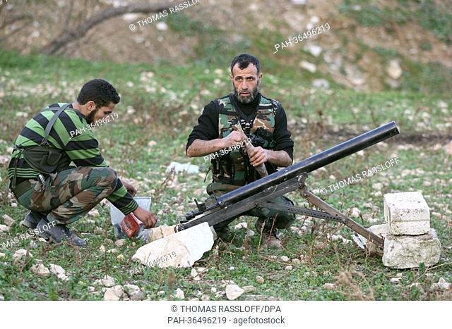 Members of the Free Syrian Army (FSA) prepare to launch a self-build mortar shell after taking control of the area and trying to defence against a...