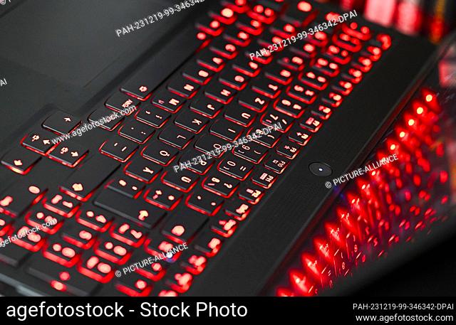 13 December 2023, Berlin: The keyboard of a laptop lights up red and is reflected on the screen. Photo: Jens Kalaene/dpa. - Berlin/Berlin/Germany