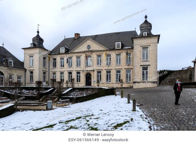 Jodoigne, Wallonia - Belgium.- Classical town hall and park in the snow