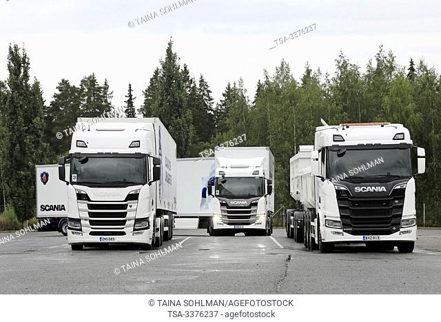 Turku, Finland. August 23, 2019. Scania G500 semi trailer parks between two other white Scania trucks, R410 and R650. Scania in Finland 70 years tour