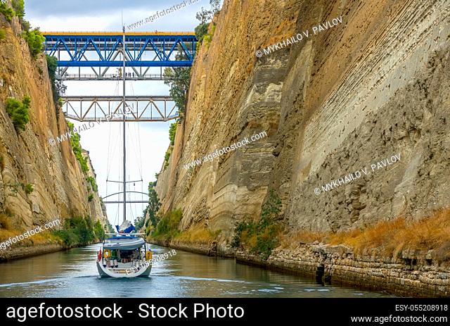 Greece. Corinth Canal in cloudy weather. Several bridges. Sailing yacht. View of the stern