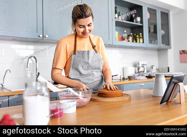 woman cooking food and baking on kitchen at home