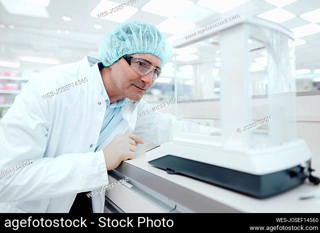 Chemist wearing protective eyewear experimenting in laboratory