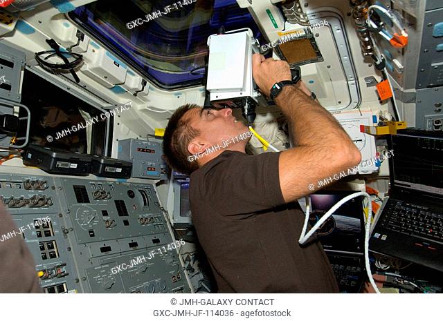Astronaut Christopher Cassidy, STS-127 mission specialist, uses a handheld laser ranging device -- designed to measure the range between two spacecraft --...