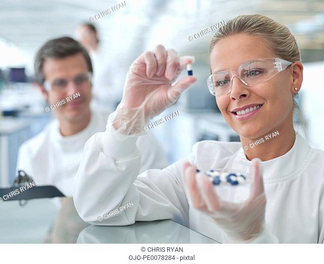 Scientist examining pills in lab