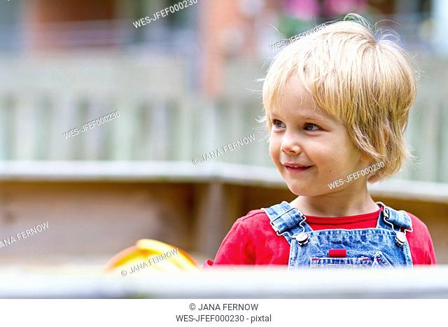Germany, Schleswig-Holstein, Kiel, little girl playing in a sandbox