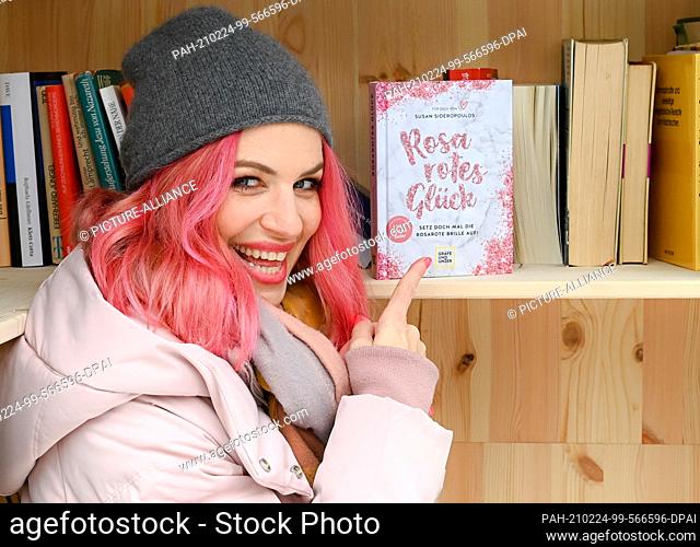 16 February 2021, Berlin: The actress and author Susan Sideropoulos puts her book ""Rosarotes Glück. Setz doch mal die rosarote Brille auf!"" in a public...