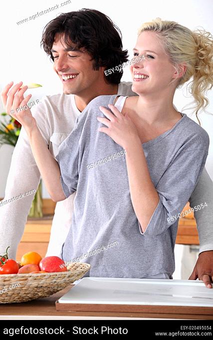 couple laughing in the kitchen