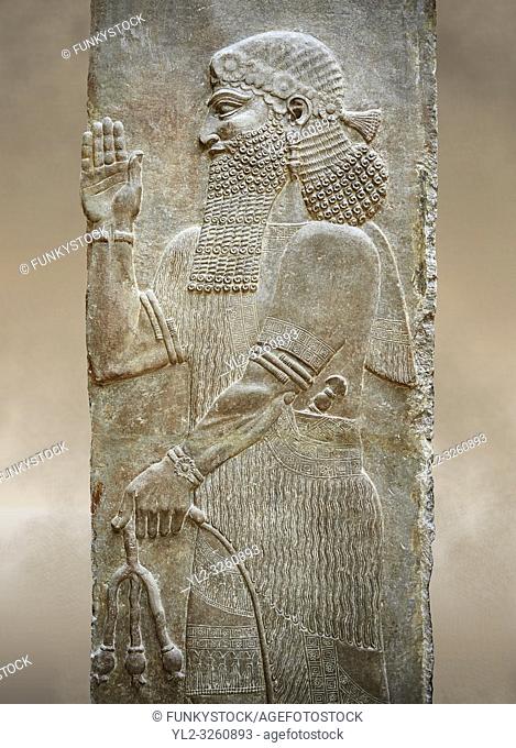 Stone relief sculptured panel of a man holding poppy seed pods. Facade N. Inv AO 19870 from Dur Sharrukin the palace of Assyrian king Sargon II at Khorsabad