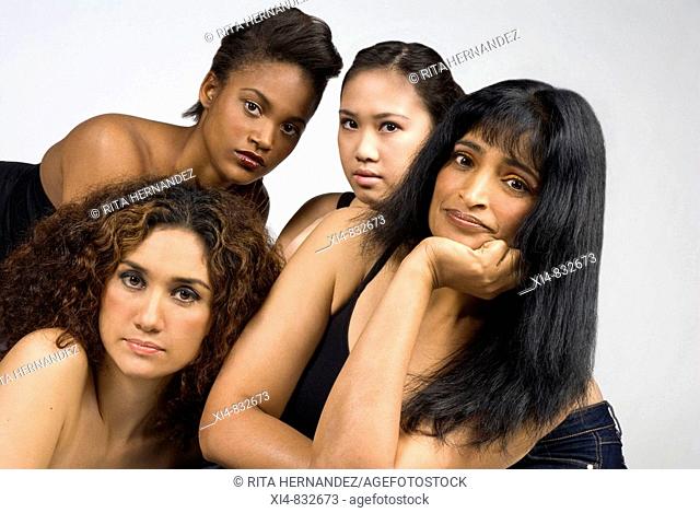 Multicultural group of four woman looking straight to the camera