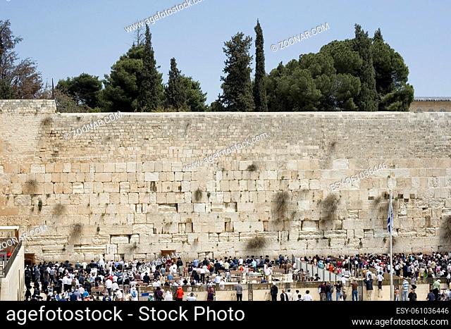 people praying at the western wall in jerusalem