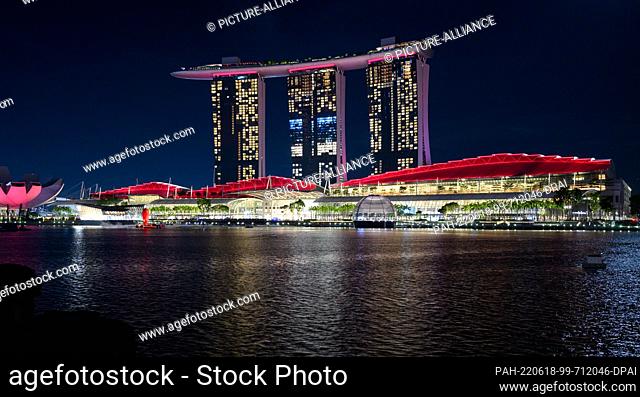 14 June 2022, Singapore, Singapur: Colorfully lit is the Marina Bay Sands Resort in Singapore. Opened in 2010, the hotel also includes a casino, a shopping mall