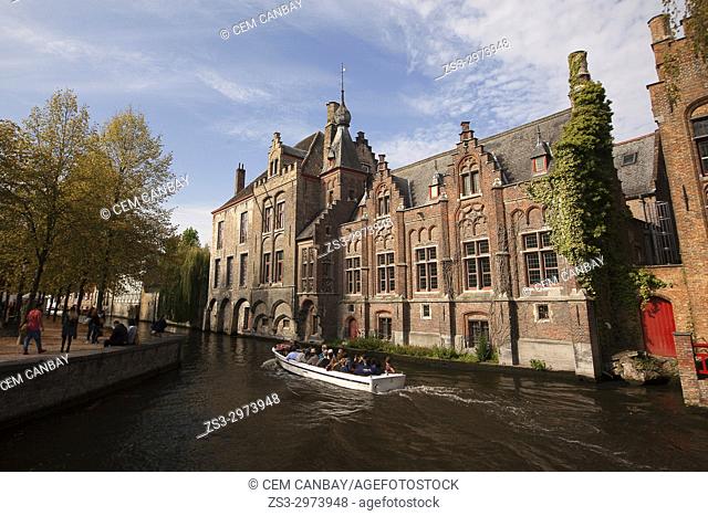 Tourists on the boat during a trip near the Rozenhoedkaai, Canal and Tower, Bruges, West Flanders, Belgium, Europe