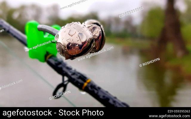 Silver fishing bells are worn on a fishing rod while fishing. Bite-call signal, at the tip of the rod. A bite alarm will alert you to a bite