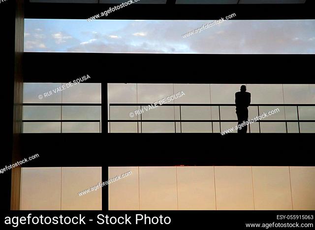 worker inside the building silhouette at sunset