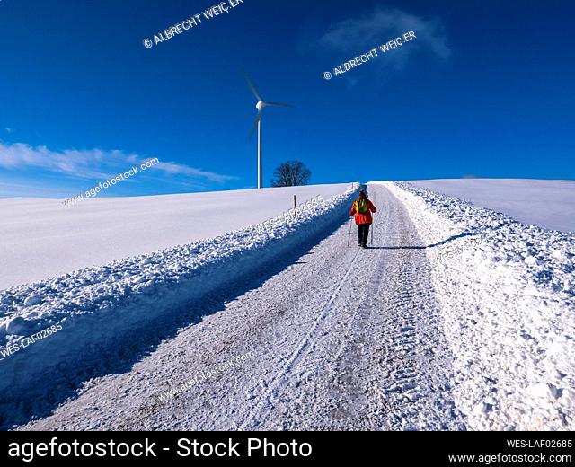 Germany, Black Forest, Freiamt, Person hiking on Schillinger Berg in winter