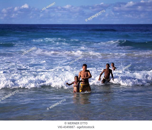 Kinder und Jugendliche baden im Meer, Jungen, Maedchen, Farbige, Mischlinge, Mulatten, Dominikanische Republik, Karibik, children and youths bathing in the sea