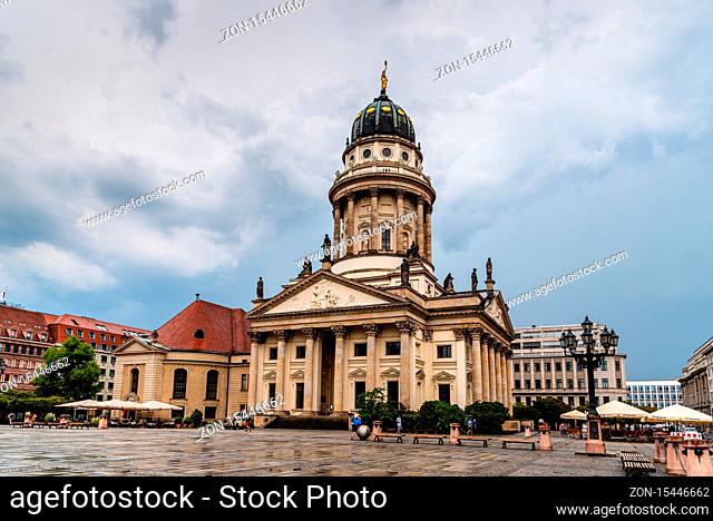 Berlin, Germany - July 29, 2019: View of Gendarmenmarkt square in Berlin Mitte a rainy day of summer. French Church