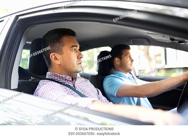 car driving school instructor and male driver