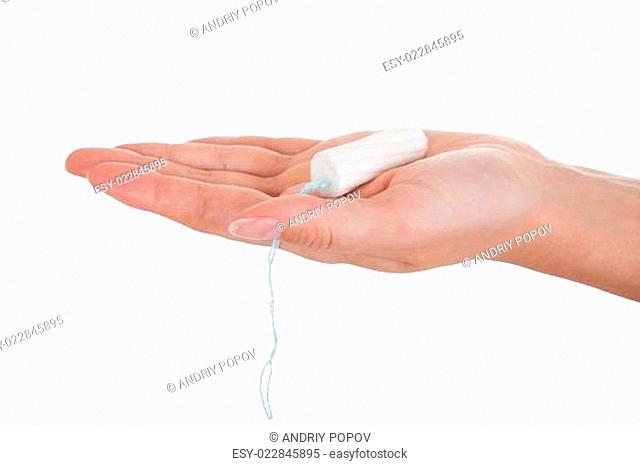 Close up of hand holding tampon