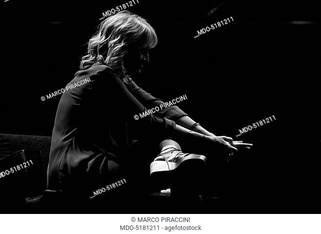 Writer and comedy actress Luciana Littizzetto sitting in profile touching her fingers during the event the Women-Ñés time at the Teatro dell'Arte of the...