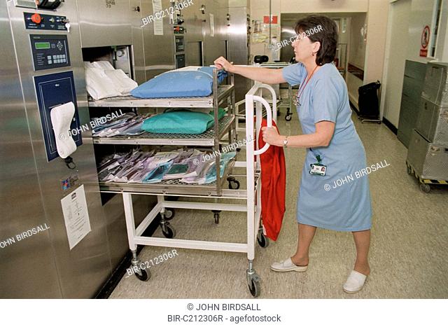 Attendant pushing trolley into Autoclave