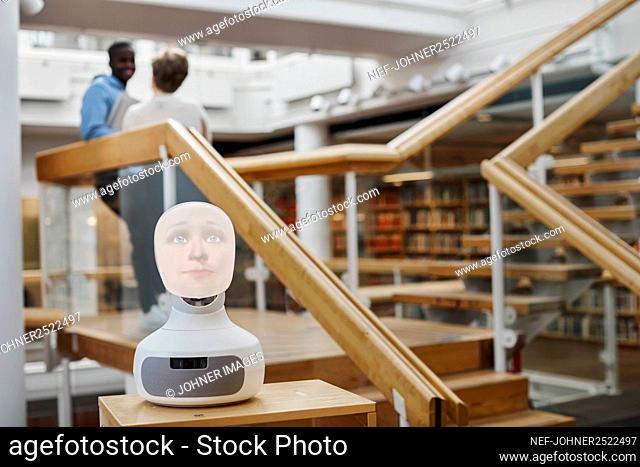 Voice assistant with human face in library