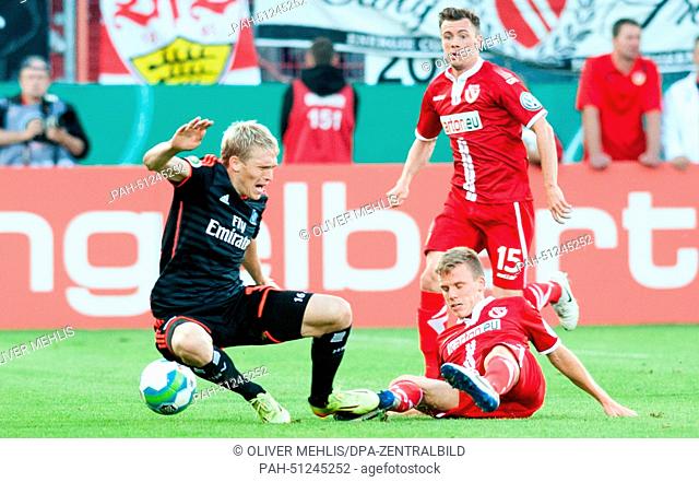 Hamburg's Artjoms Rudnevs (L-R) and Cottbus' Nikolas Ledgerwood in action during the DFB Cup first round match between FC Energie Cottbus and Hamburg SV at the...