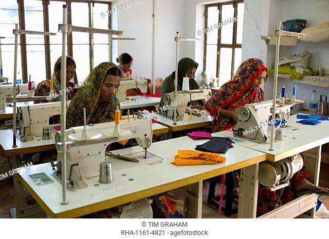 Indian women sewing textiles at Dastkar women's craft co-operative, the Ranthambore Artisan Project, in Rajasthan, Northern India
