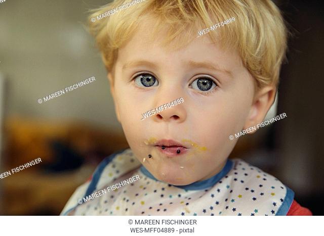 Portrait of blond little boy eating caviar and egg