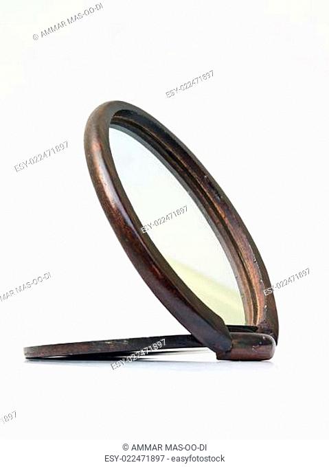 A wooden pocket makeup mirror isolated on white background
