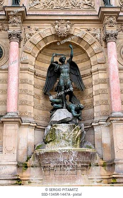 Statue at a fountain, Fontaine Saint-Michel, Place Saint-Michel, Latin Quarter, Paris, Ile-de-France, France