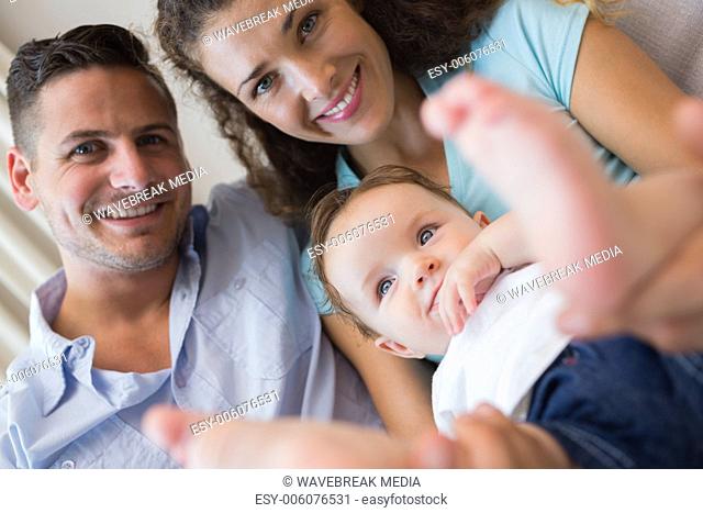 Smiling parents with cute baby