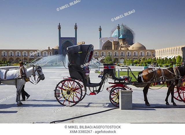 Tourist carriage and the Shah Mosque. Naghsh-e Jahan Square. Isfahan, Iran. Asia