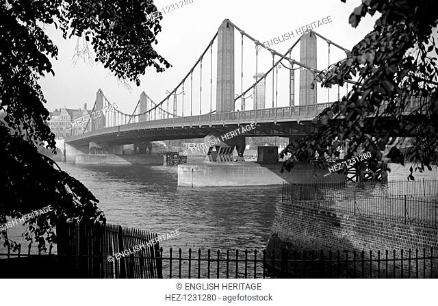 Chelsea Bridge from Battersea Park, London, c1945-c1965. View framed by trees of the present rather austere bridge which dates from 1934