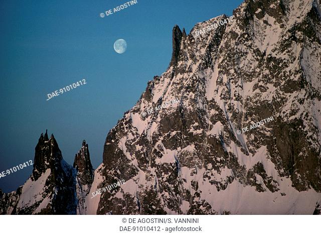 Les Dames des Anglaises (3, 601 metres) at sunset with the moon in the sky seen from Torino refuge, Mont Blanc massif, Graian Alps, Aosta Valley, Italy