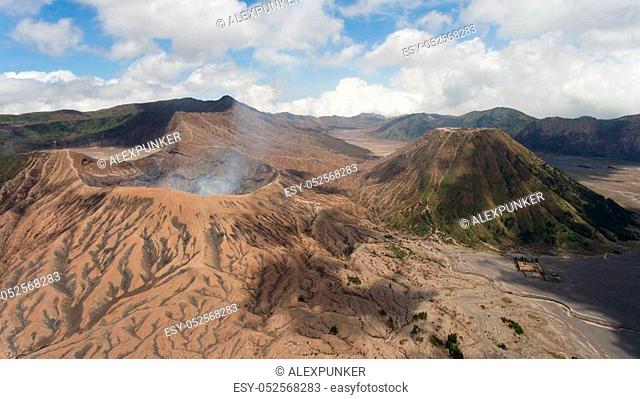Crater with active volcano smoke in East Jawa, Indonesia. Aerial view of volcano crater Mount Gunung Bromo is an active volcano, Tengger Semeru National Park