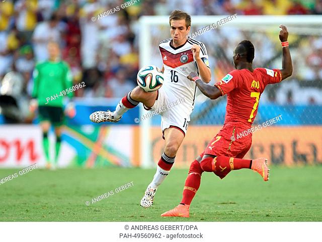 Philipp Lahm of Germany vies for the ball with Christian Atsu (R) of Ghana during the FIFA World Cup 2014 group G preliminary round match between Germany and...
