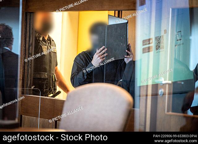 06 September 2022, North Rhine-Westphalia, Cologne: The defendant is led into the courtroom. After the violent death of a mother and her son near the Rhine