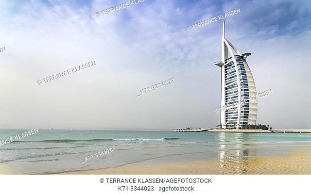 The Burj Al Arab Hotel and reflections in a sandy beach in Dubai, UAE, Middle East